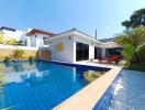 Modern house with swimming pool and sun loungers