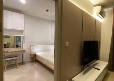 Modern bedroom with attached living space and kitchenette