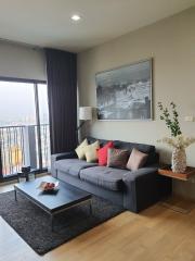 Cozy and modern living room with large window and city view