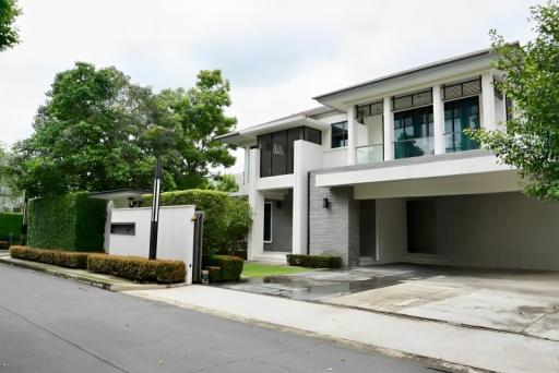 Modern residential home facade with lush greenery