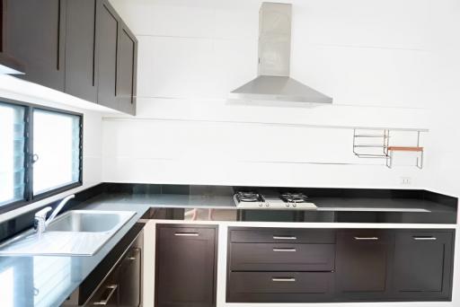 Modern kitchen with dark cabinets and stainless steel appliances