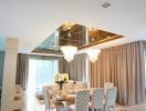 Elegant dining room with modern chandeliers and large mirror ceiling