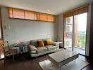 Modern living room with natural light and balcony access