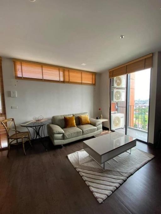 Modern living room with natural light and balcony access