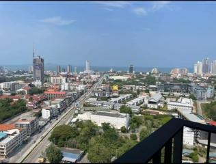 High-rise balcony view overlooking the cityscape and ocean