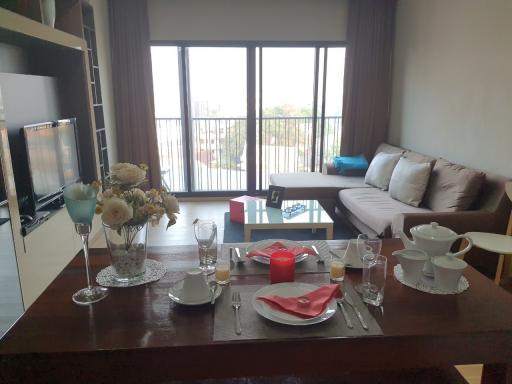 Cozy living room with dining table set and a view from the balcony