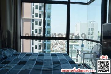 Modern bedroom with large window offering city views