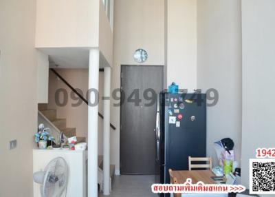 Compact entrance area of a modern apartment with a refrigerator and wooden furniture