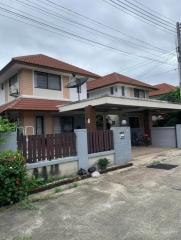 Two-story residential home with a gated front yard