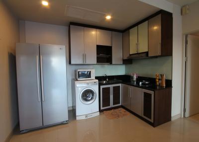 Modern kitchen with stainless steel appliances and wooden cabinets