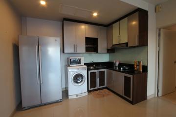 Modern kitchen with stainless steel appliances and wooden cabinets