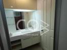 Compact bathroom with white fixtures and overhead lighting