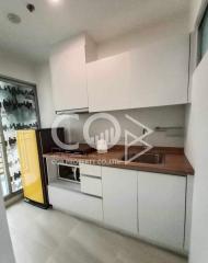 Modern kitchen interior with white cabinets and a yellow fridge