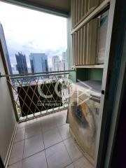 City view from a high-rise apartment balcony with security grille