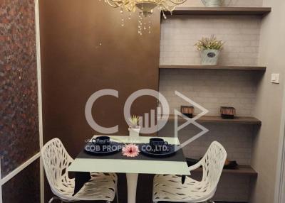 Elegant dining area with chandelier and built-in shelving