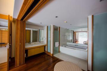 Modern bedroom with en-suite bathroom and wooden finishes