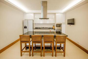 Modern kitchen with dining area and built-in appliances