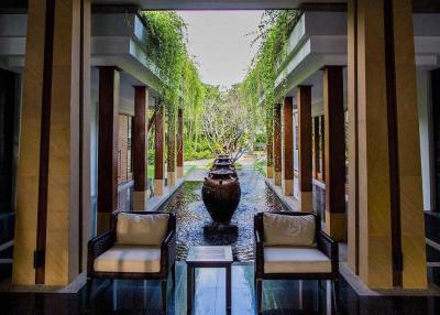Elegant property entrance with symmetrical design and water feature