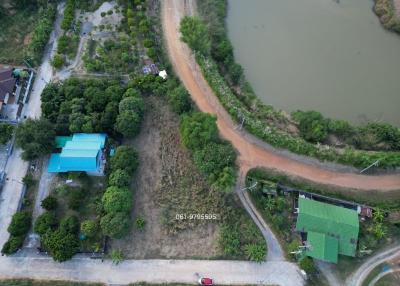 Aerial view of a property with surrounding land and water body
