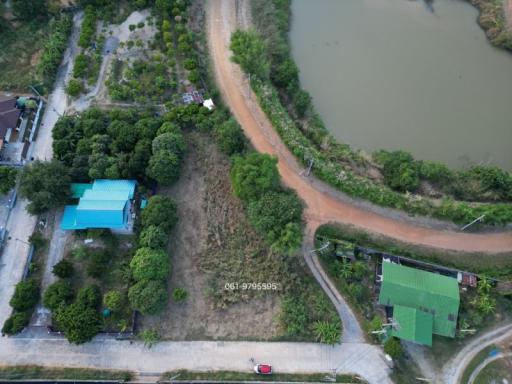 Aerial view of a property with surrounding land and water body