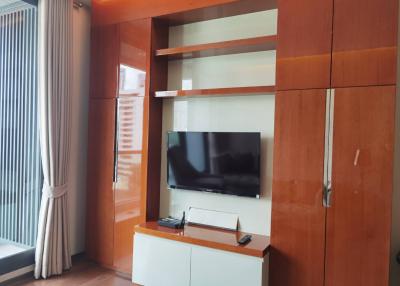 Modern living room with a mounted television and wooden paneling