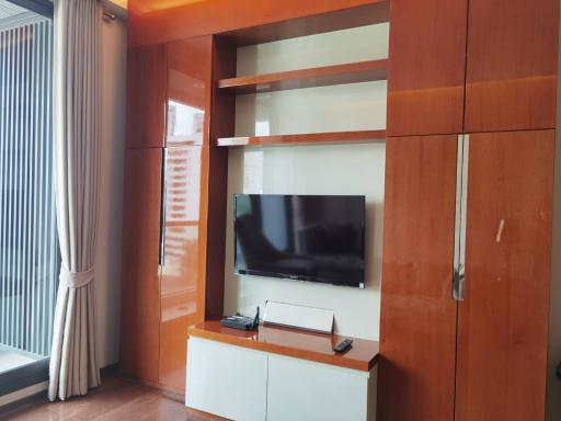 Modern living room with a mounted television and wooden paneling