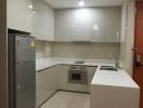 Modern kitchen with stainless steel appliances and white cabinetry