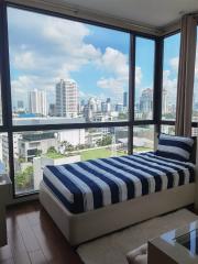 Modern bedroom with large windows and city view