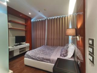 Modern bedroom with large bed and TV