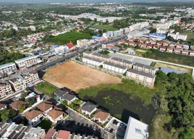 Aerial view of a residential area with various properties and potential vacant land for development