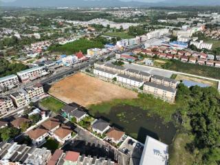 Aerial view of a residential area with various properties and potential vacant land for development