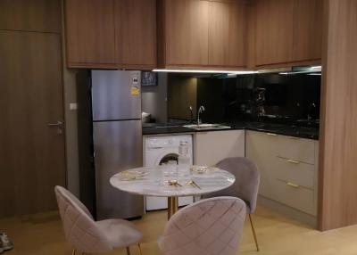 Modern kitchen with dining area and wooden cabinets