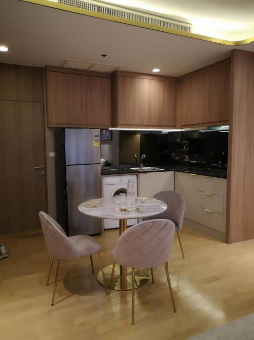 Modern kitchen with dining area and wooden cabinets