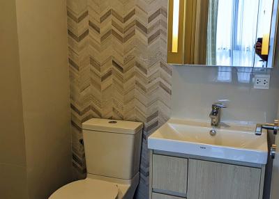 Modern bathroom with patterned walls and sleek fixtures