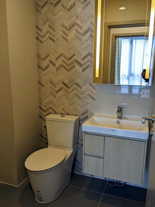 Modern bathroom with patterned walls and sleek fixtures