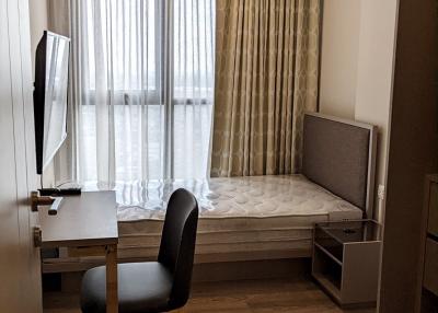 Cozy modern bedroom with a large window and natural light