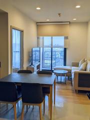 Modern living room with dining area and balcony access