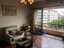 Cozy living room with comfortable seating and balcony access