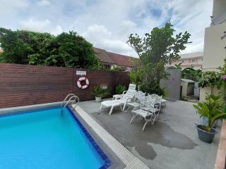 Private swimming pool with loungers and garden in residential property