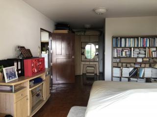 Cozy bedroom with ample shelving and en suite bathroom access