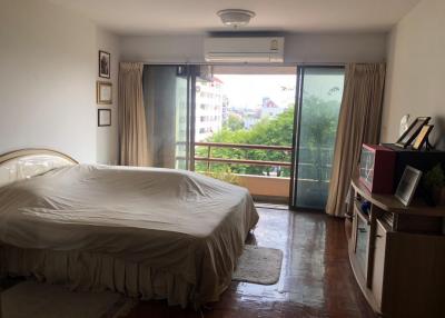 Spacious bedroom with natural light and balcony access