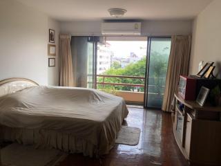 Spacious bedroom with natural light and balcony access