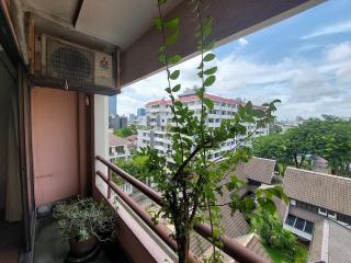 Spacious balcony with urban view and potted plants