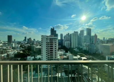 City view from high-rise balcony with clear skies