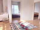 Bright and spacious living room with open doorway to a well-lit bedroom