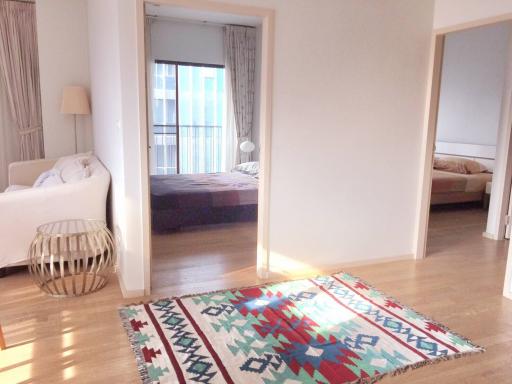 Bright and spacious living room with open doorway to a well-lit bedroom