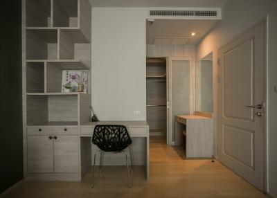 Modern hallway interior with decorative shelving unit and minimalist chair