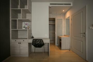 Modern hallway interior with decorative shelving unit and minimalist chair