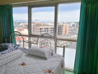 Bright bedroom with large windows and city view