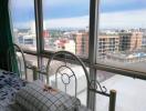 Bedroom with a view of the cityscape through large windows